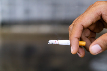 A hand man holding cigaret. Stop smoking concept