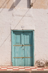 Obraz na płótnie Canvas Street and a house with blue wooden door