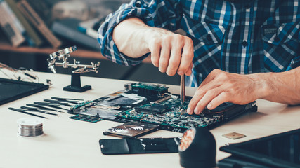 Fototapeta Computer repair technician working on motherboard obraz