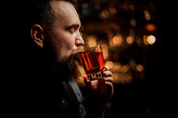 Portrait of bartender sipping an alcohol cocktail