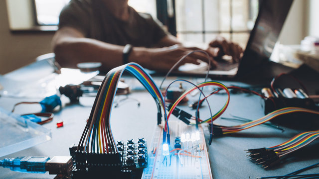 Modern technology. Student working at laboratory workstation. Microcontroller programming. Education and practical experience.