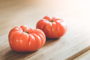 Oxheart tomatoes. Tomatoes on a bamboo wood plate.