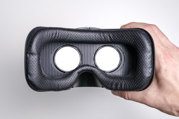 close up virtual reality glasses in male hand on white background,