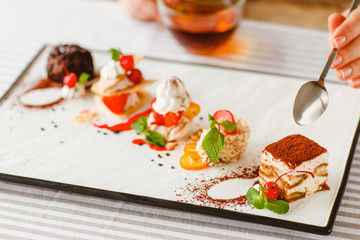 Dessert degustation. Wedding menu. Restaurant buffet food. Gastronomy cakes assortment on white plate.