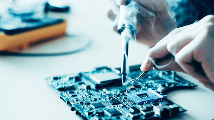 Technology microelectronics science education. Engineer student learning to solder electronic...