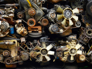 pile of old cars spare parts in rubbish heap