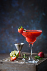 Ice Strawberry alcohol cocktail with lime and rum in a glass