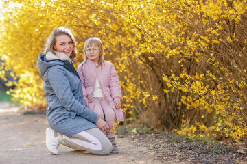 Fototapeta premium Mother and little daughter playing together in a park