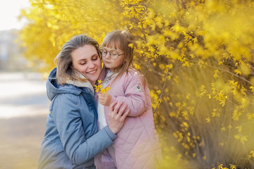 Fototapeta premium Mother and little daughter playing together in a park