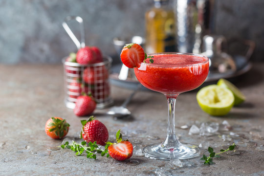 Ice Strawberry alcohol cocktail with lime and rum in a glass