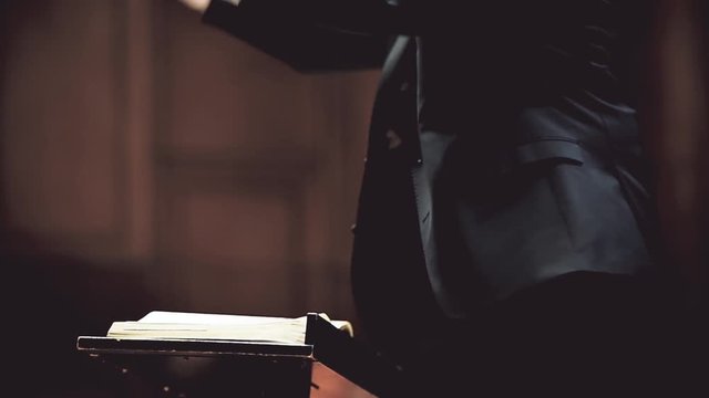 Orchestra conductor hands detail during philharmonic orchestra performance