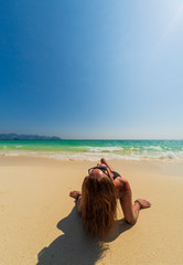 Fototapeta na wymiar Woman enjoying her holidays on the tropical beach