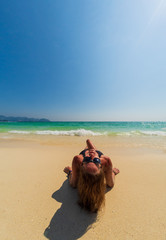 Fototapeta na wymiar Woman enjoying her holidays on the tropical beach
