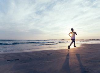 young healthy lifestyle woman running at sunrise beach