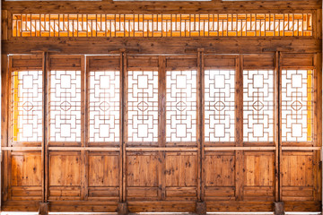Closeup Chinese old wooden frame door with decorative pattern under the sunshine ,view from inside...