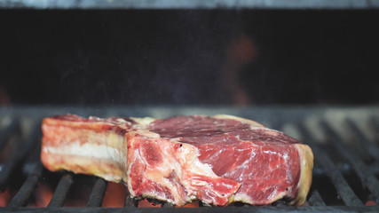 Beef veal or lamb steak is grilled in the restaurant kitchen.