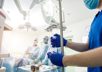 Arthroscope surgery. Orthopedic surgeons in teamwork in the operating room with modern arthroscopic tools. Knee surgery.