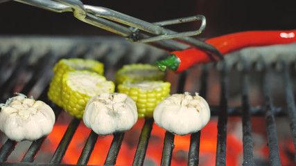 Close up delicious Mexican corn barbecue on cob grill over glowing coals. Ready to eat. Street food appetizing grilled corn on the barbecue grill.