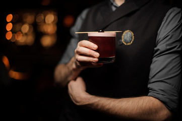 Close shot of bartender with an alcohol cocktail