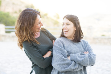 Fototapeta premium Beautiful family of mother and daugther smiling cheerful, two happy women together as woman power