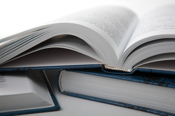 open books with other books on a gray table