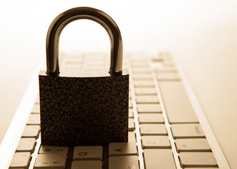 padlock on a computer keyboard Internet security concept