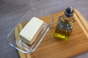 Bottle of olive oil and glassware with butter