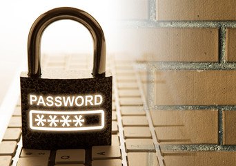 Door lock on a computer keyboard with brick wall Internet security concept
