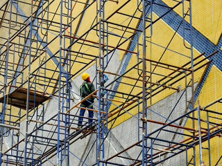 Construction workers working on scaffolding in construction site