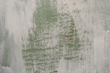 Obraz premium green wall with white strokes of paint. Background and texture.