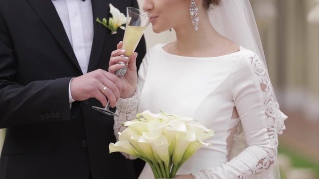Newlyweds dring a champagne on wedding ceremony