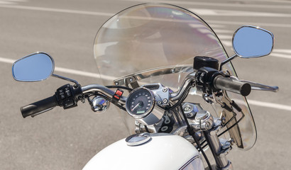 white classic motorcycle chopper on a city street close up