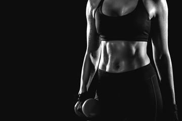 Black and white photo of the press girl holding a dumbbell in her hand. - 263914146