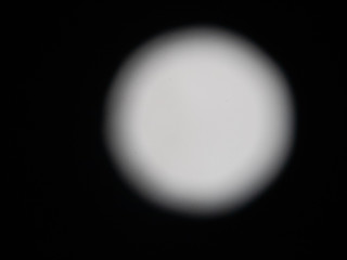 Fototapeta na wymiar A white blurred moon photo.