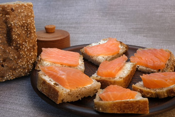Small sandwiches on homemade bread with butter and red fish
