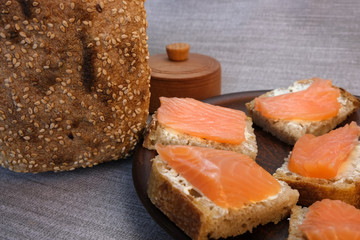 Small sandwiches on homemade bread with butter and red fish