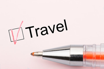 Travel - checkbox with a cross on white paper with pen. Checklist concept.