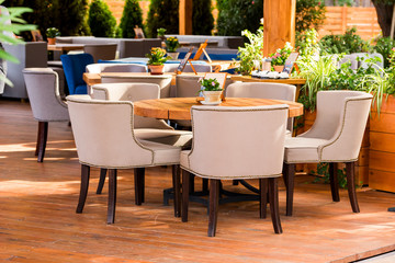 modern outdoor furniture in a cafe on the summer area, tables and chairs