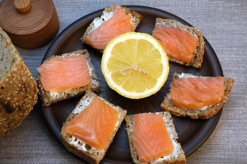 Small sandwiches on homemade bread with butter and red fish