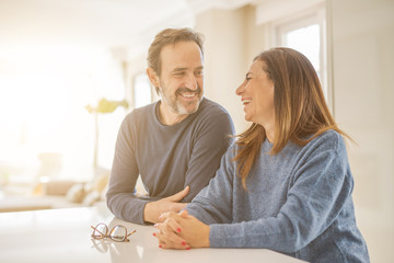 Romantic middle age couple sitting together at home