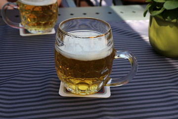 Mug of light beer stands on the table