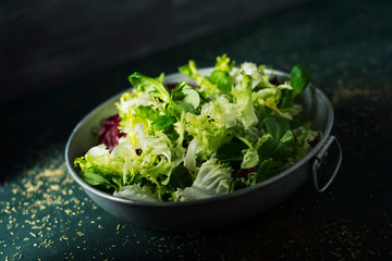 mix of different salad leaves in a metal dish