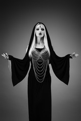 Portrait of a shaman with arms outstretched