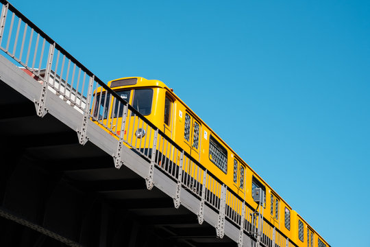The Berlin U-Bahn train (metro train) U1 on elevated railroad bridge outdoor -