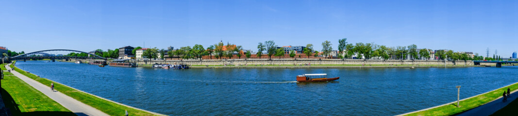 Fototapeta na wymiar wooden boat goes along the river in Krakow