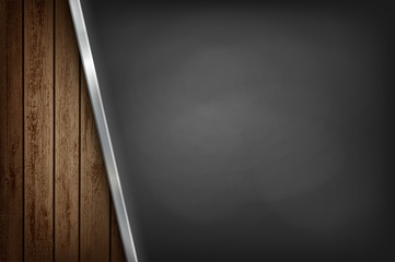 Black metal empty plate on wooden background.