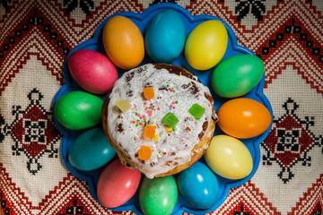 top view of decorated easter bread and dyed easter eggs