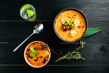 Tom Yam kung Spicy Thai soup with shrimp, seafood, coconut milk and chili pepper in bowl copy space