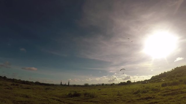 Soldiers arriving by parachute in an open field 1