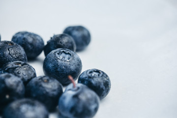 fresh blueberry berries on a white plate close-up. breakfast of wild berries. copy space